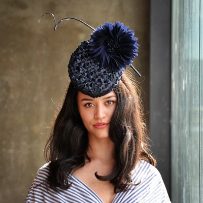 navy percher with large flower and quill