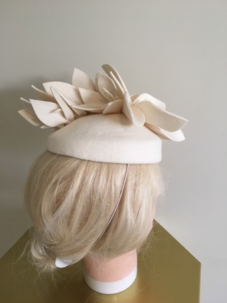 Cute cream felt pill box perfect for winter racing .