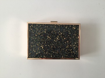 For Rent: Black and gold clutch