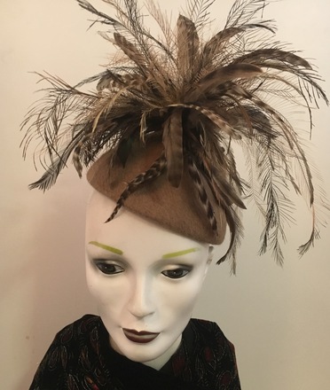 Taupe fur felt with profusion of feathers