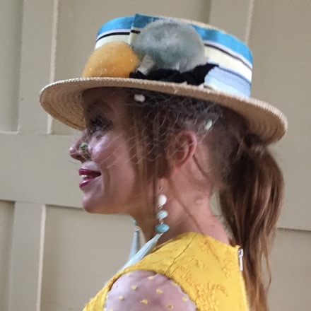 Straw boater with vintage ribbon, pom poms and veiling