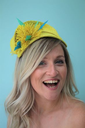 Yellow raffia headpiece with blue feather detail