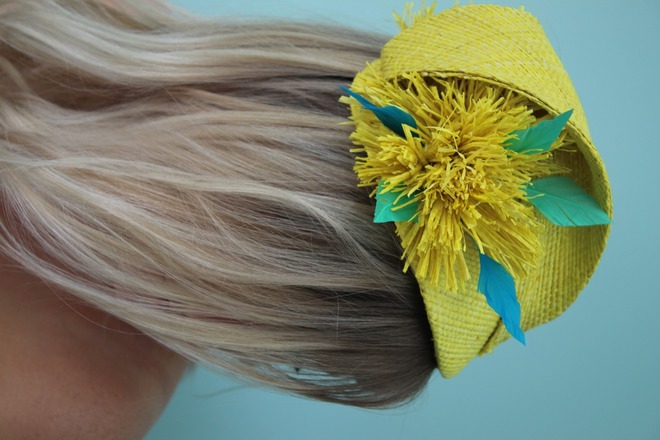 Yellow raffia headpiece with blue feather detail