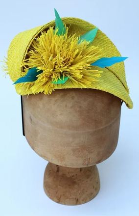 Yellow raffia headpiece with blue feather detail