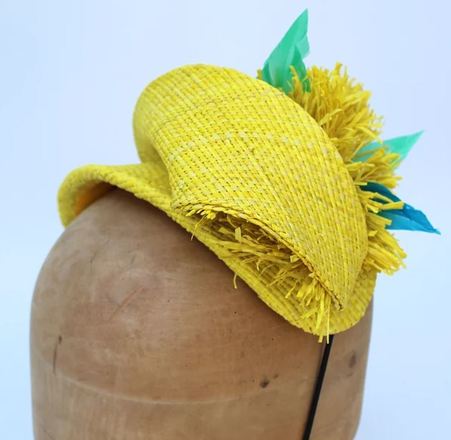Yellow raffia headpiece with blue feather detail