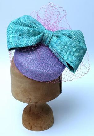 Lilac Sinamay pillbox with large blue raffia bow and vieling
