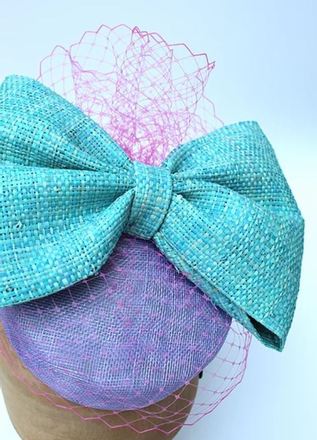 Lilac Sinamay pillbox with large blue raffia bow and vieling