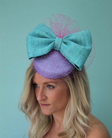 Lilac Sinamay pillbox with large blue raffia bow and vieling