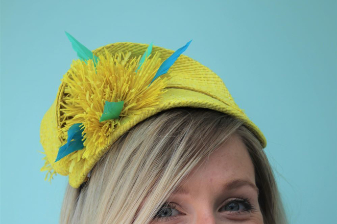 Yellow raffia headpiece with blue feather detail